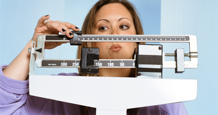 Frustrated woman on the scale